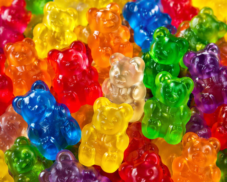 Saffron strands and natural supplement ingredients on a wooden surface.